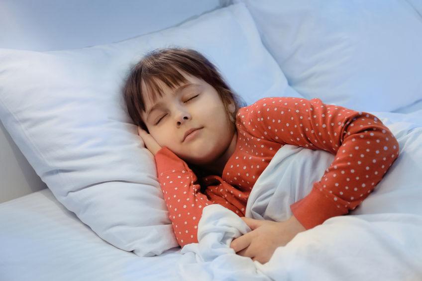 child sleeping in clean bedroom