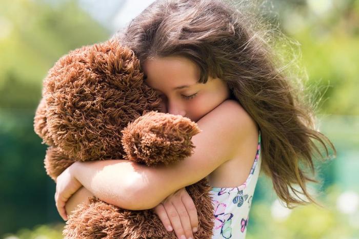 girl hugging teddy bear