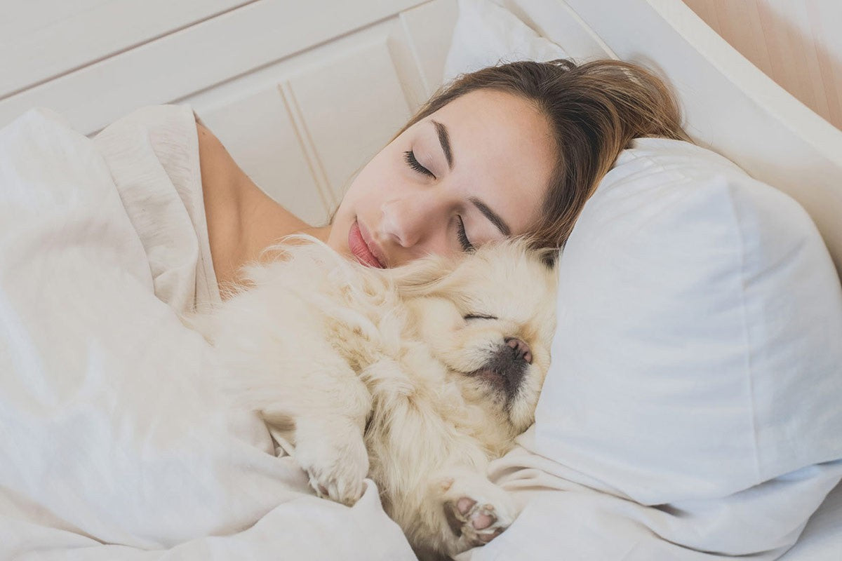 girl sleeping with her dog
