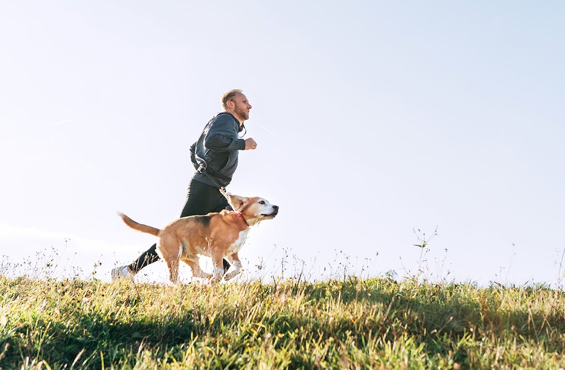 man jogging with his dog